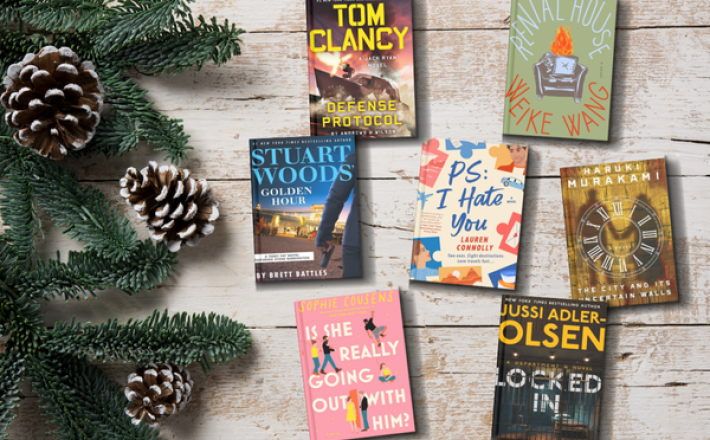 Books sitting against a winter backdrop with pine leaves